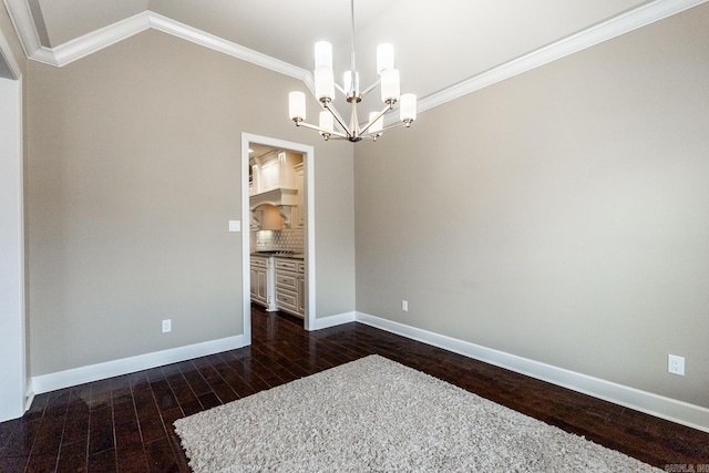 spare room featuring a notable chandelier, dark hardwood / wood-style flooring, and crown molding