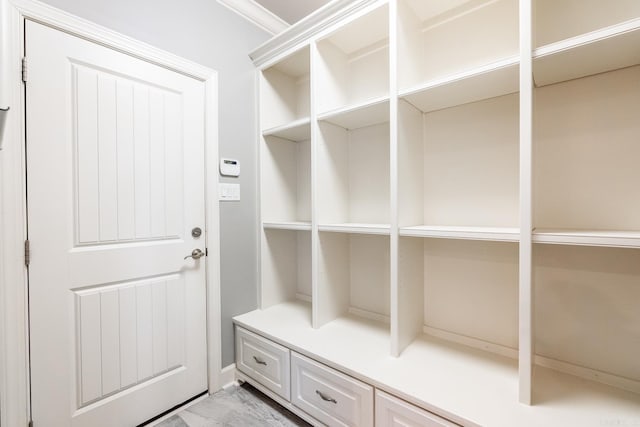 mudroom featuring crown molding