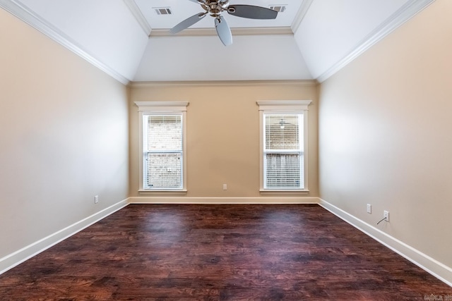 empty room featuring ornamental molding, dark wood-type flooring, vaulted ceiling, and a healthy amount of sunlight