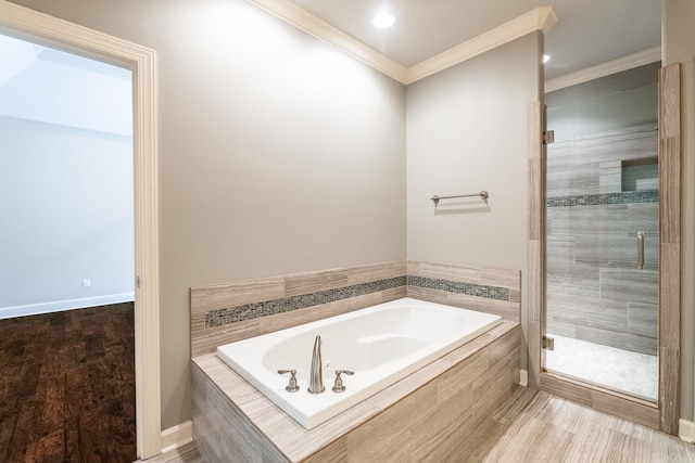 bathroom with hardwood / wood-style flooring, ornamental molding, and plus walk in shower