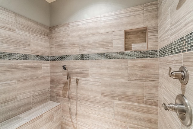 bathroom with a tile shower