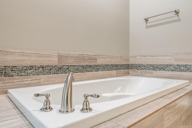 bathroom with tiled bath