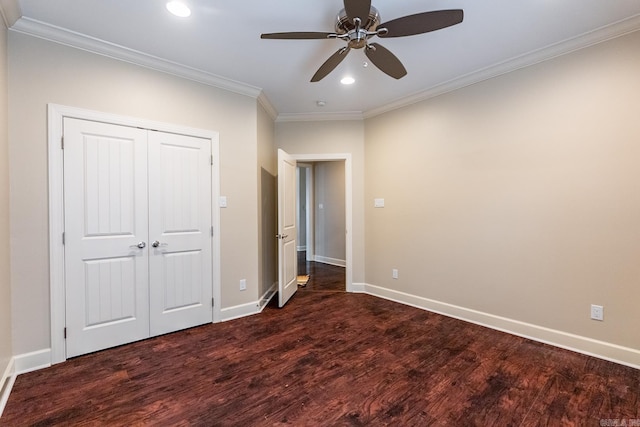 unfurnished bedroom with ceiling fan, dark hardwood / wood-style flooring, ornamental molding, and a closet