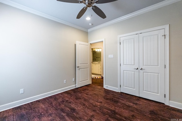 unfurnished bedroom featuring ceiling fan, crown molding, dark wood-type flooring, and a closet