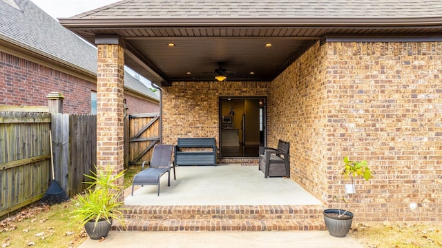 entrance to property with ceiling fan and a patio area