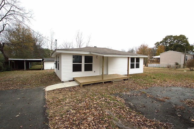 view of front of home featuring a deck and a carport