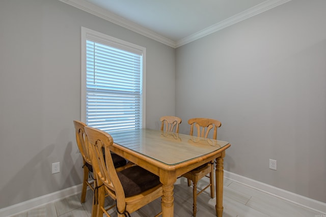 dining space featuring crown molding