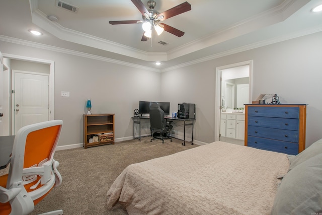 bedroom with light carpet, a tray ceiling, ceiling fan, and crown molding