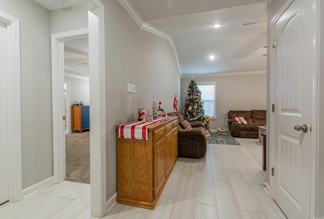 hallway featuring light colored carpet and ornamental molding