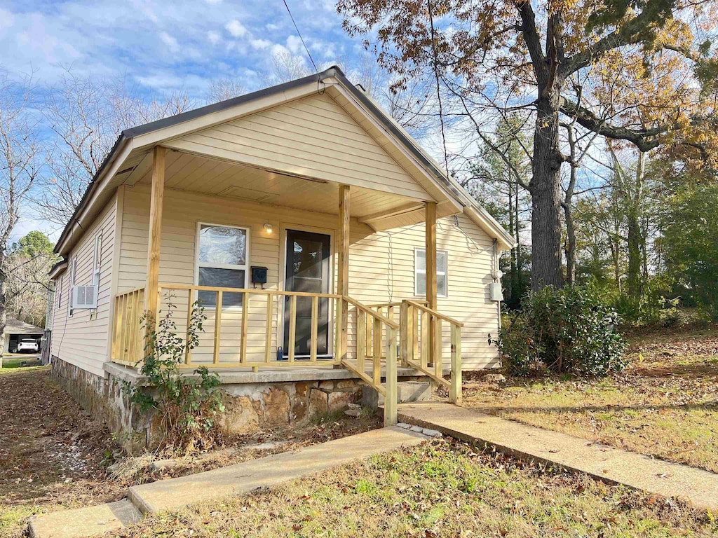 bungalow-style house featuring covered porch and cooling unit