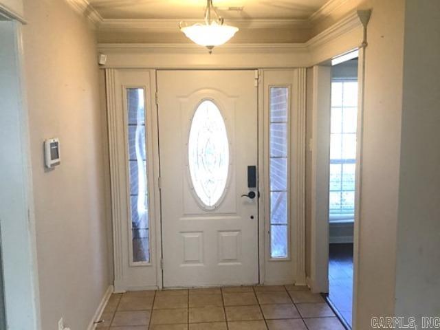 tiled foyer with ornamental molding