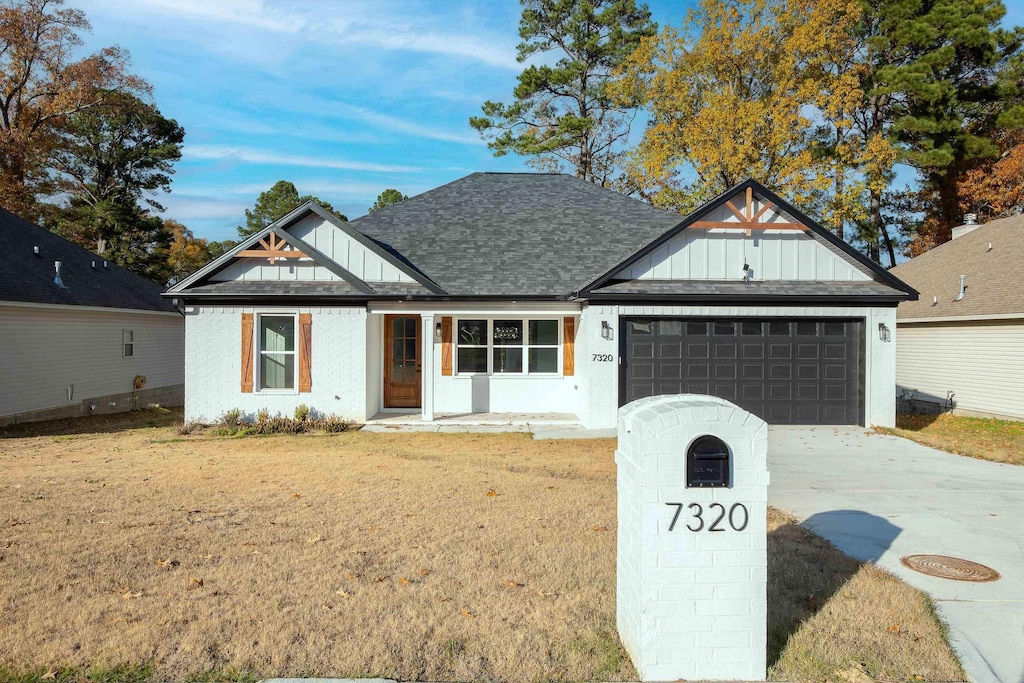 view of front of property featuring a garage and a front lawn