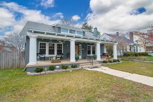 back of house with a lawn, ceiling fan, and covered porch