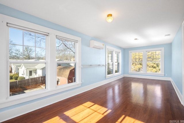 interior space with wood-type flooring and a wall mounted AC