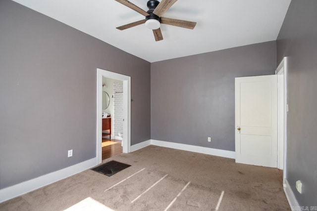 unfurnished bedroom with carpet flooring, ceiling fan, and ensuite bathroom