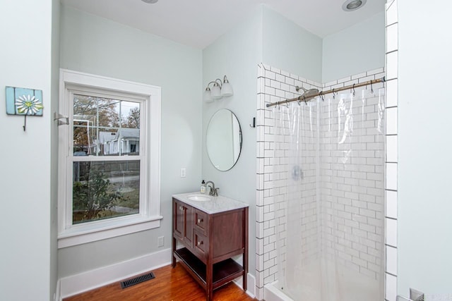 bathroom with hardwood / wood-style floors, a shower with curtain, and vanity