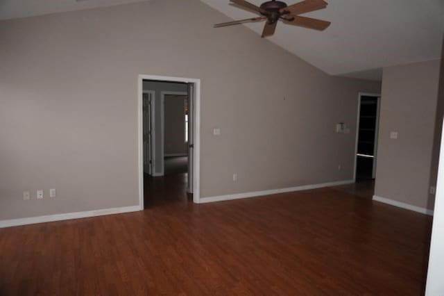 empty room featuring lofted ceiling, dark wood-type flooring, and ceiling fan