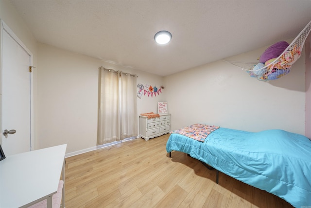 bedroom with hardwood / wood-style flooring