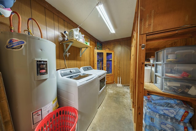 laundry area with separate washer and dryer, wooden walls, and water heater