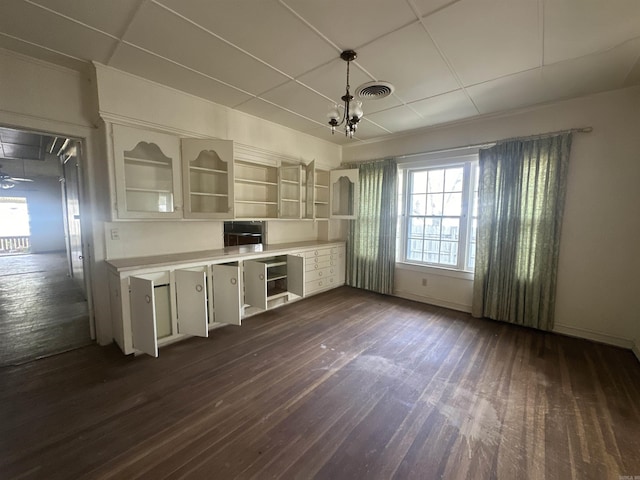 kitchen featuring dark wood-type flooring and a chandelier