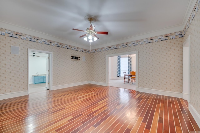 unfurnished room featuring hardwood / wood-style floors, ceiling fan, and ornamental molding