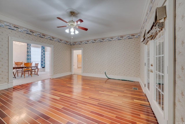 empty room with hardwood / wood-style floors, ceiling fan, and ornamental molding