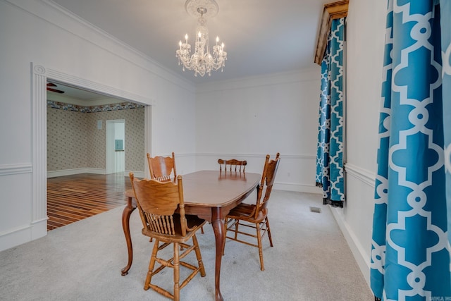 dining room featuring a notable chandelier, wood-type flooring, and crown molding