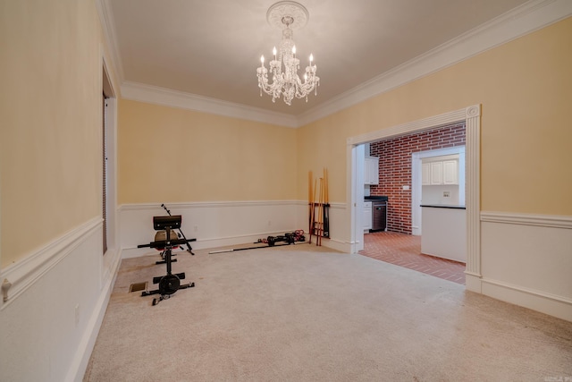 exercise area with carpet, crown molding, and a chandelier