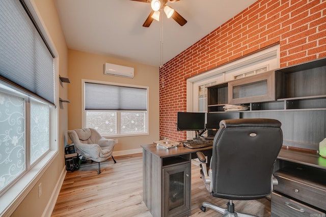 home office featuring a wall mounted AC, ceiling fan, light hardwood / wood-style flooring, and brick wall