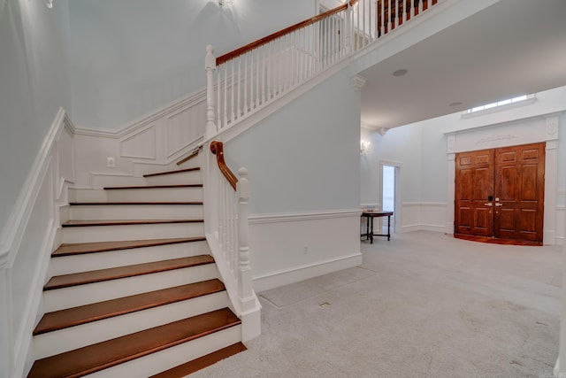 staircase featuring carpet floors