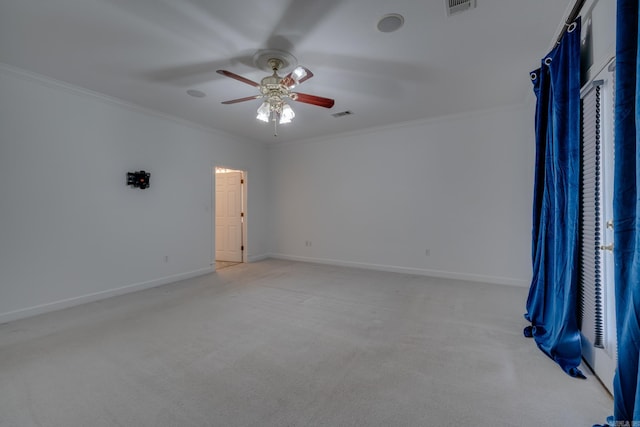 empty room with ceiling fan, light colored carpet, and ornamental molding