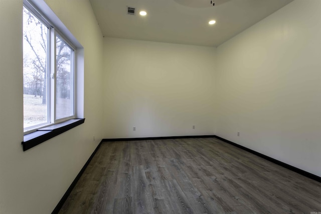 unfurnished room with dark wood-type flooring