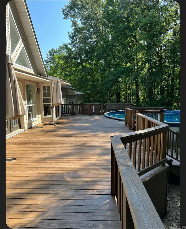 wooden deck featuring a fenced in pool