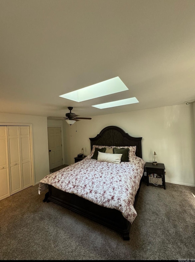 carpeted bedroom with a skylight, ceiling fan, and a closet