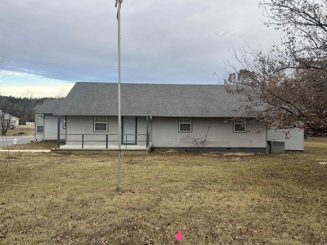 rear view of house with a patio area, cooling unit, and a yard