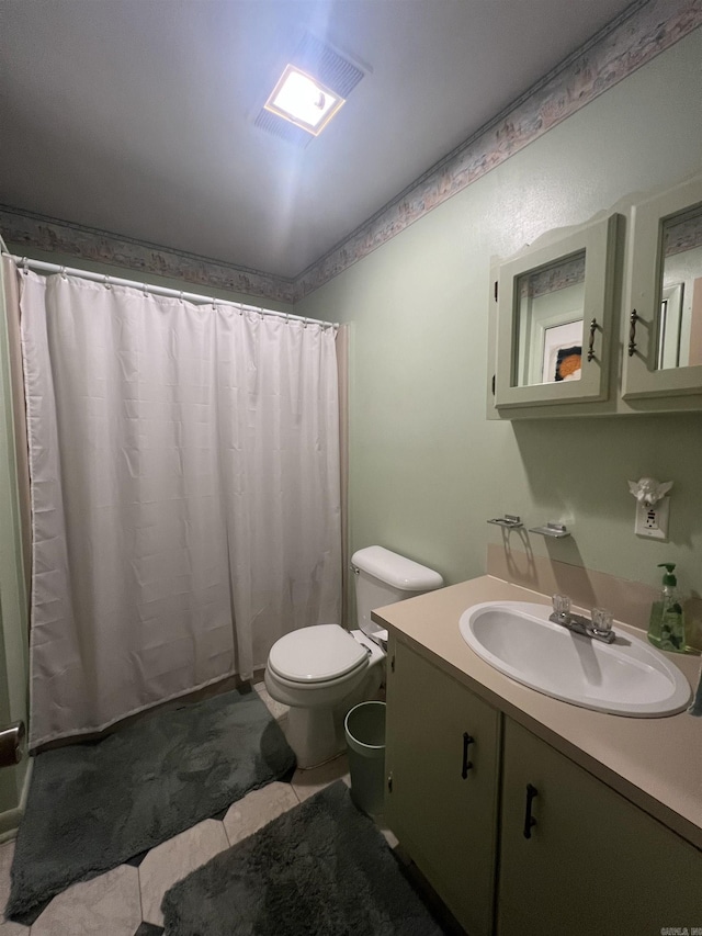 bathroom with tile patterned flooring, a shower with curtain, vanity, and toilet