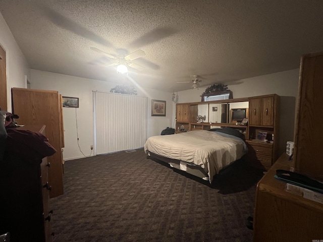 bedroom featuring ceiling fan, a textured ceiling, and dark colored carpet