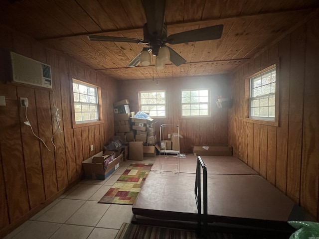 interior space featuring wooden ceiling, light tile patterned floors, and wood walls