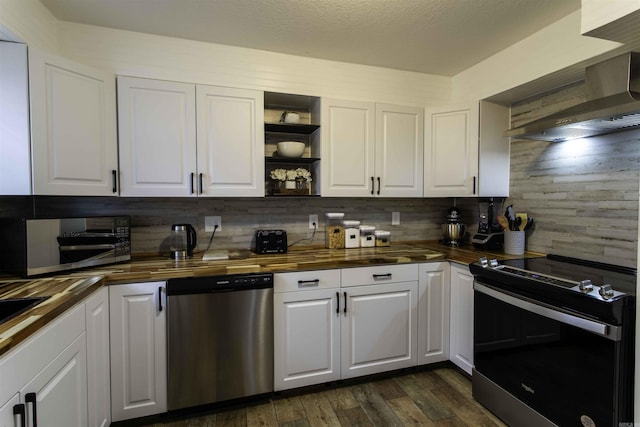 kitchen with white cabinetry, electric range, wall chimney exhaust hood, wood counters, and stainless steel dishwasher