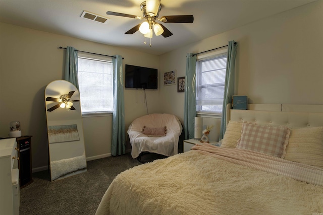 bedroom with dark colored carpet and ceiling fan