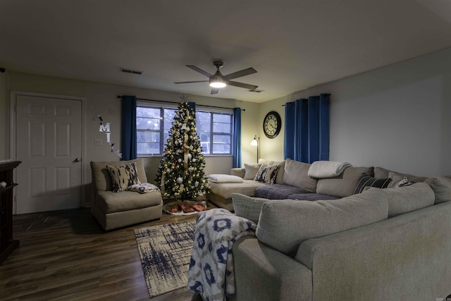 living room featuring ceiling fan and dark wood-type flooring