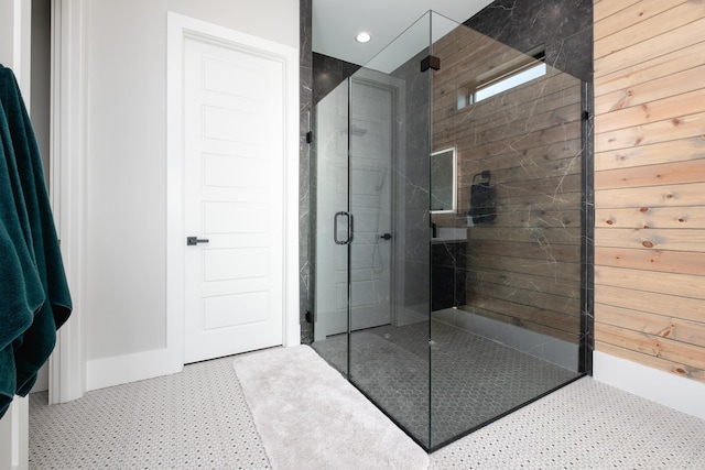 bathroom featuring a shower with door