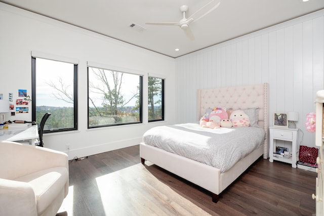 bedroom featuring ceiling fan, dark hardwood / wood-style flooring, and multiple windows