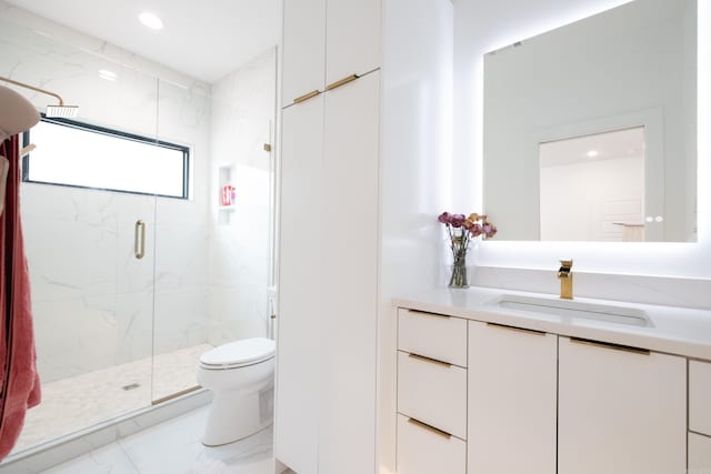 bathroom featuring vanity, toilet, and an enclosed shower