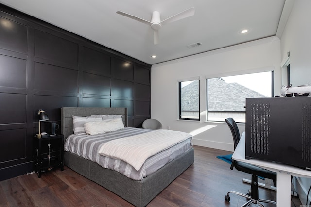 bedroom featuring dark hardwood / wood-style flooring, ceiling fan, and ornamental molding