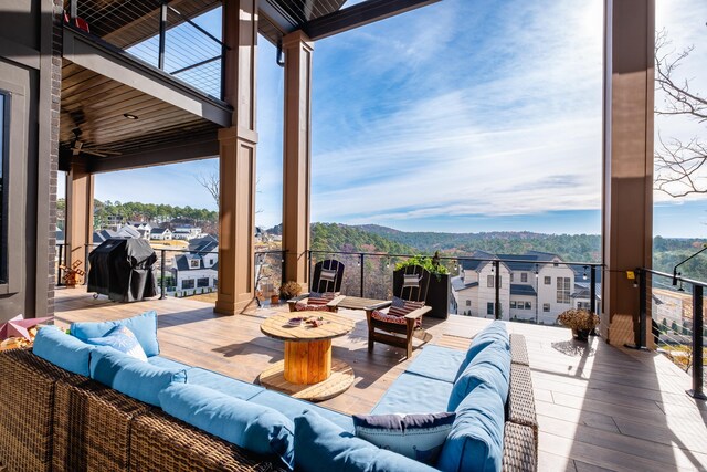 view of patio featuring a mountain view, an outdoor hangout area, and a balcony