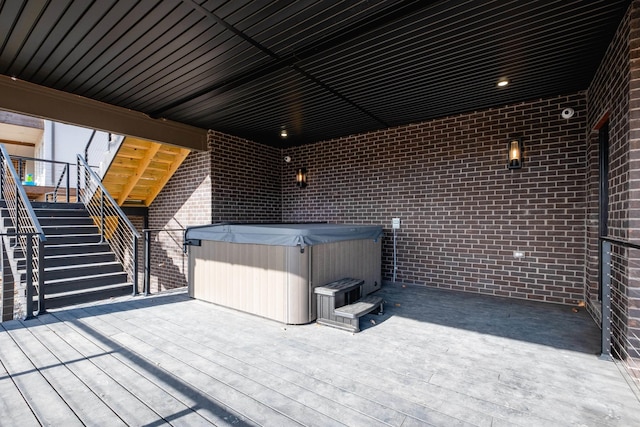 wooden deck featuring a hot tub