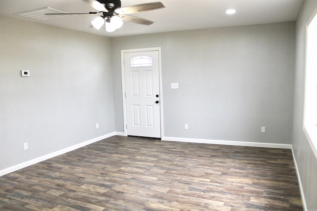 unfurnished room with ceiling fan and dark wood-type flooring