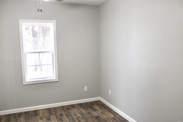 unfurnished room with dark wood-type flooring