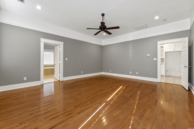 empty room featuring hardwood / wood-style flooring and ceiling fan